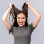 stressed-young-pretty-woman-pulling-her-hair-isolated-white-background_141793-31776